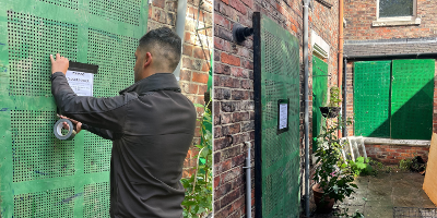 Two images side by side - the left shows an enforcement officer attaching a Closure Order notice to a boarded up door of a house on Yarm Road. The right shows the boarded up door plus boarded up windows. All are covered by green metal barriers.