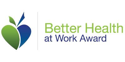 The Better Health at Work Award logo, consisting of the words Better Health at Work Award in green and blue alongside a motif which combines two halves of a heart shape with what looks like an apple core running through it.