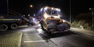 A dramatic night time shot of a yellow tarmac vehicle carrying road resurfacing materials for a road resurfacing job at Haverton Hill.