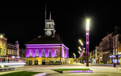 An image of Stockton Town Hall lit up in purple