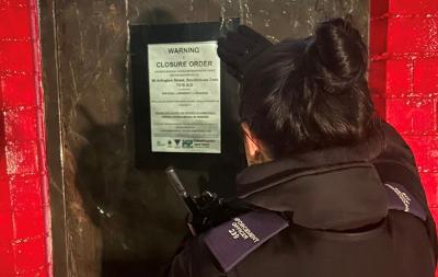 Civic Enforcement Officer displays closure order