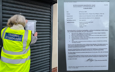 A trading standards officer attaches a closure notice to the shop shutters