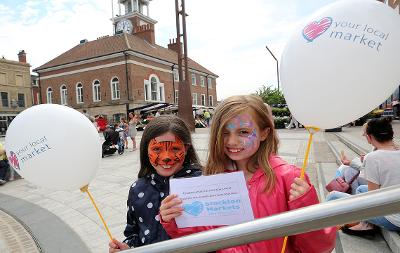 Children celebrating the Love Your Local Market event in Stockton