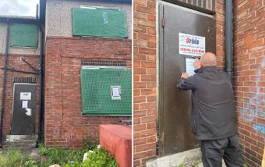 Council officer putting up an order on a building